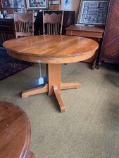 Round Oak pedestal table with two leaves - $225